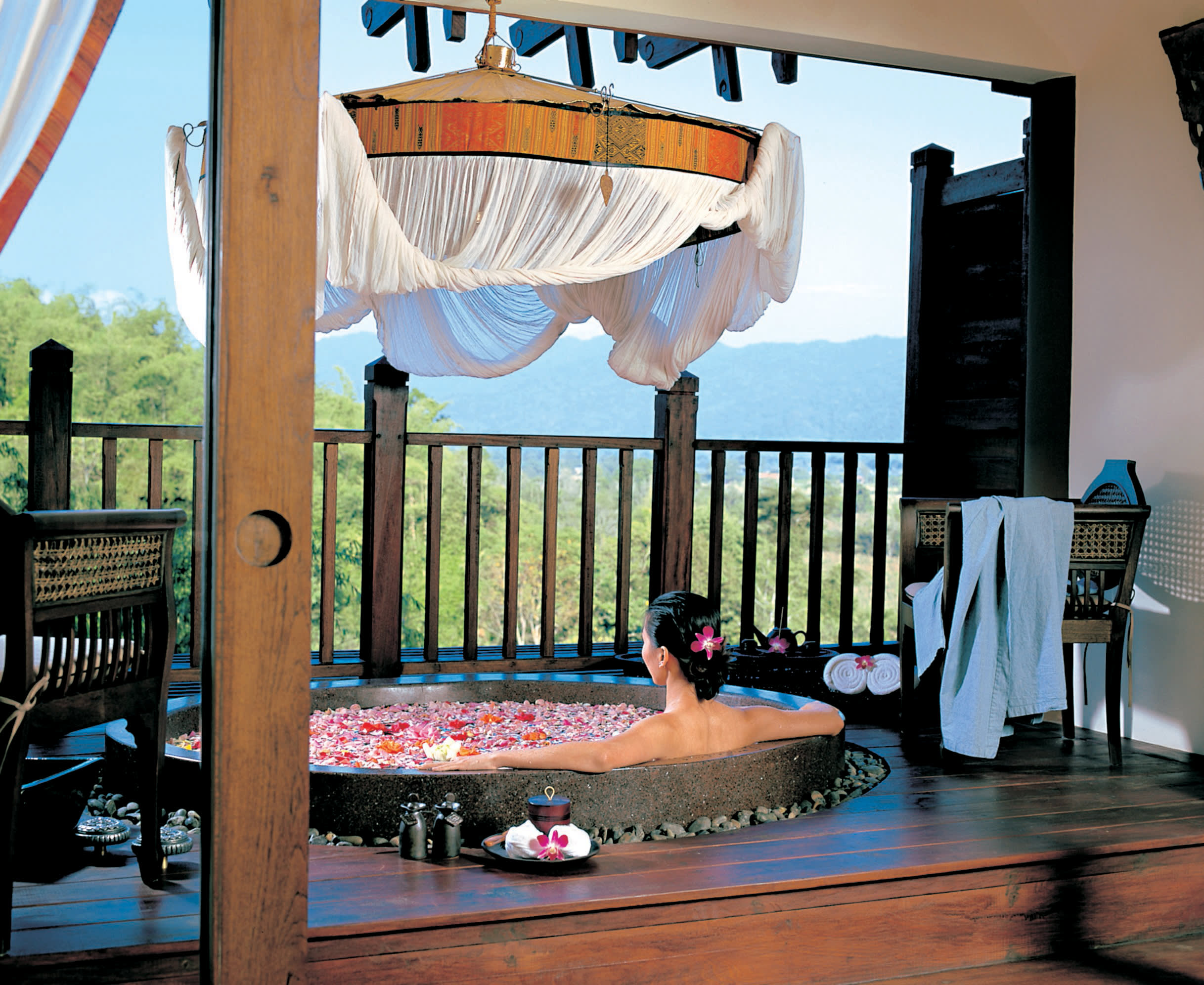a group of people sitting at a table with an umbrella
