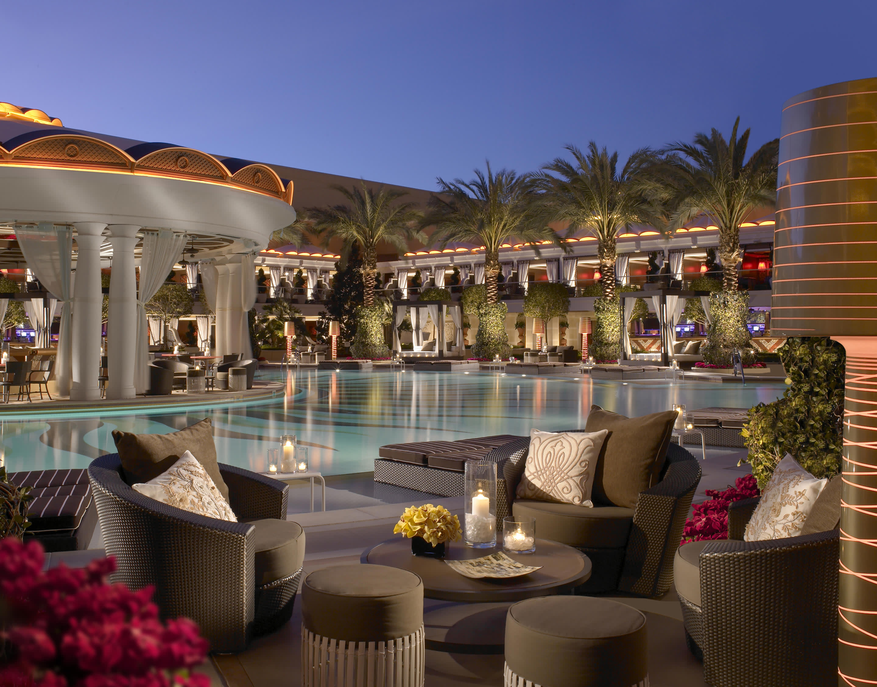 a room filled with furniture and vase of flowers on a table