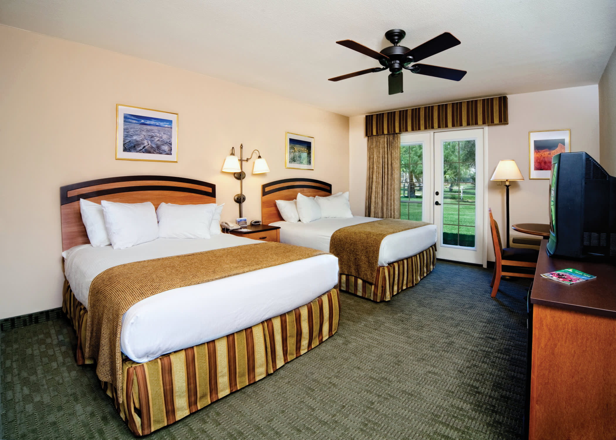 a bedroom with a bed and desk in a room