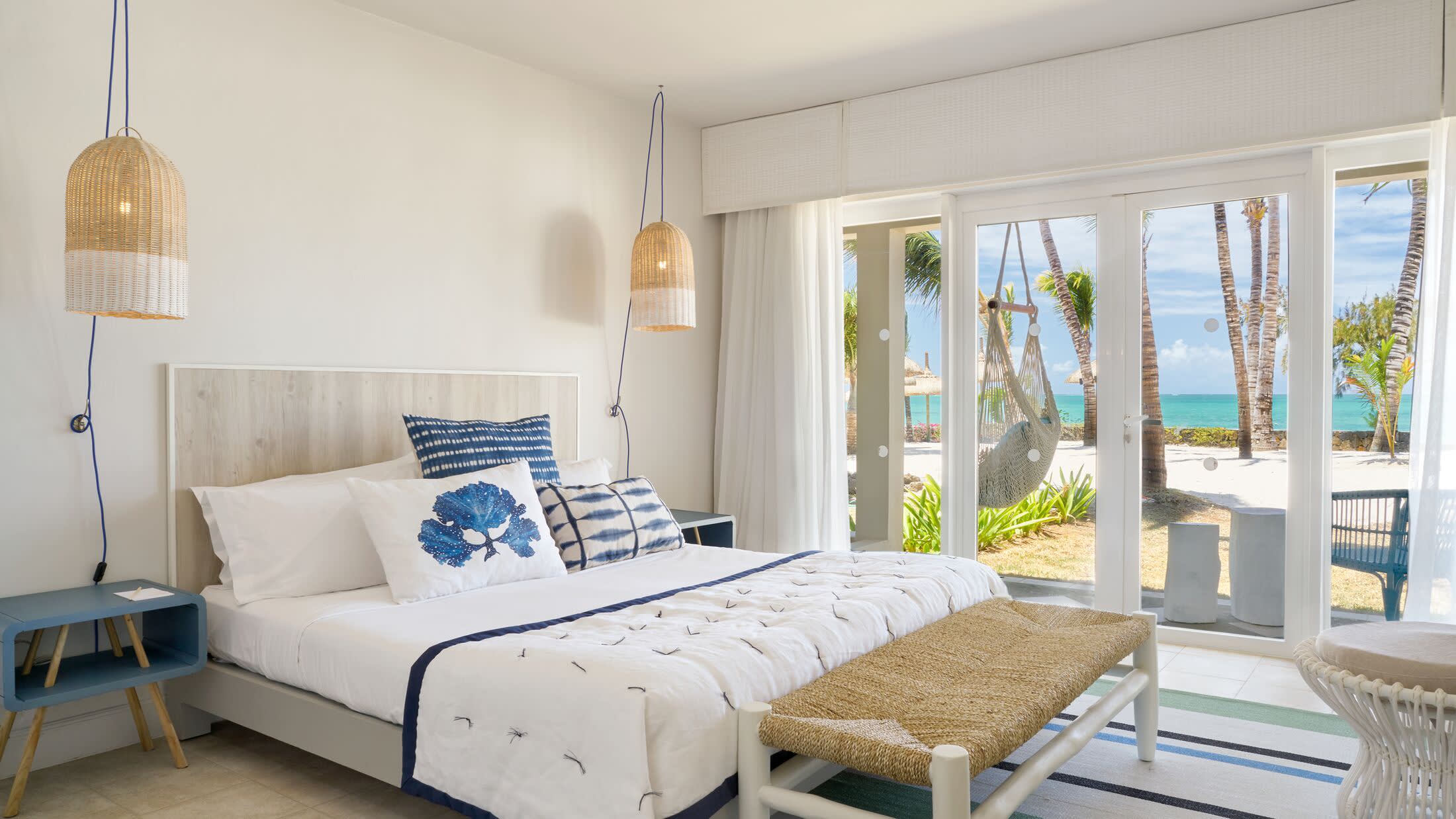 a bedroom with a bed and a chair in a room