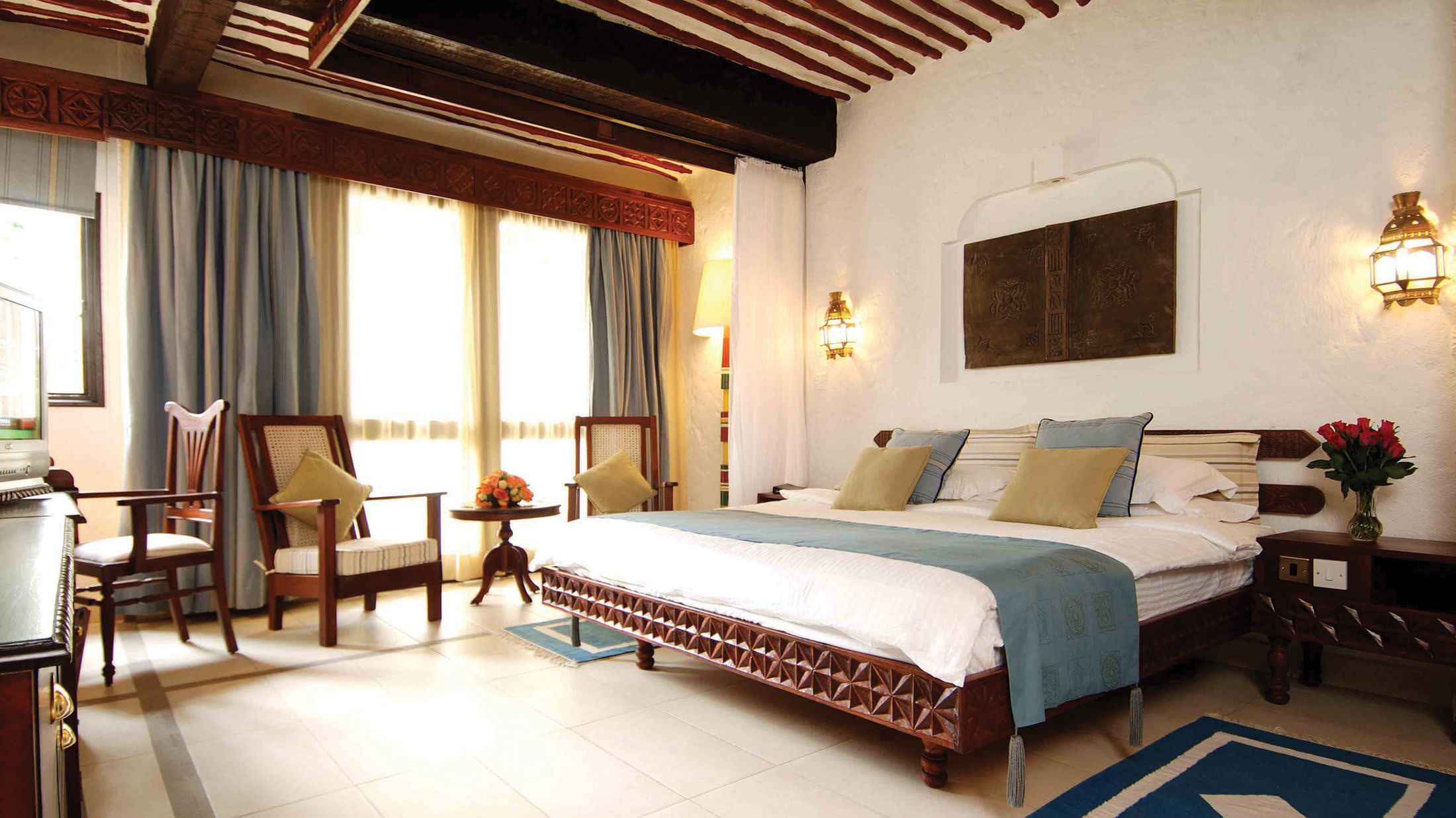 a bedroom with a large bed in a hotel room