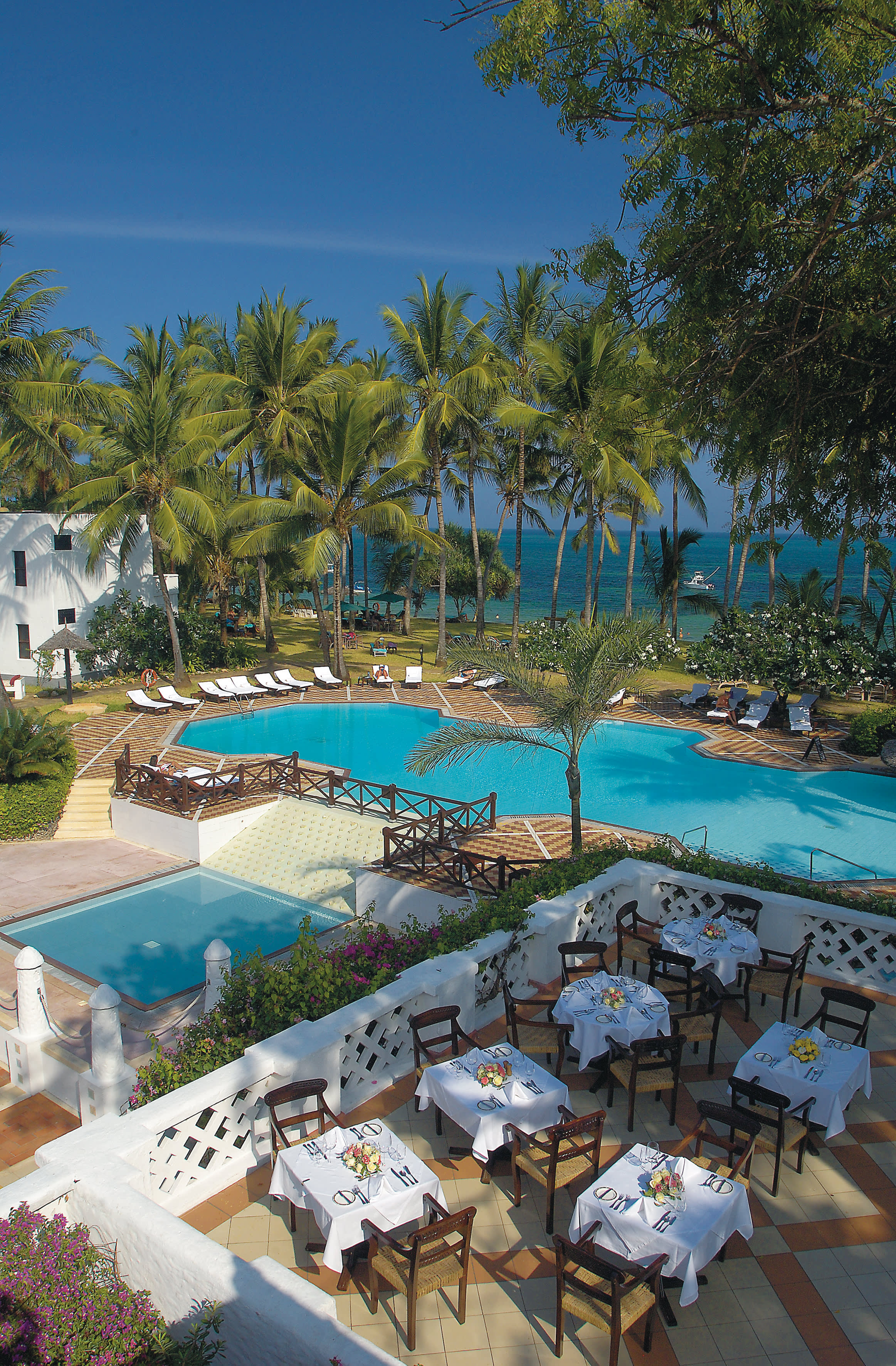 a garden with water in the background