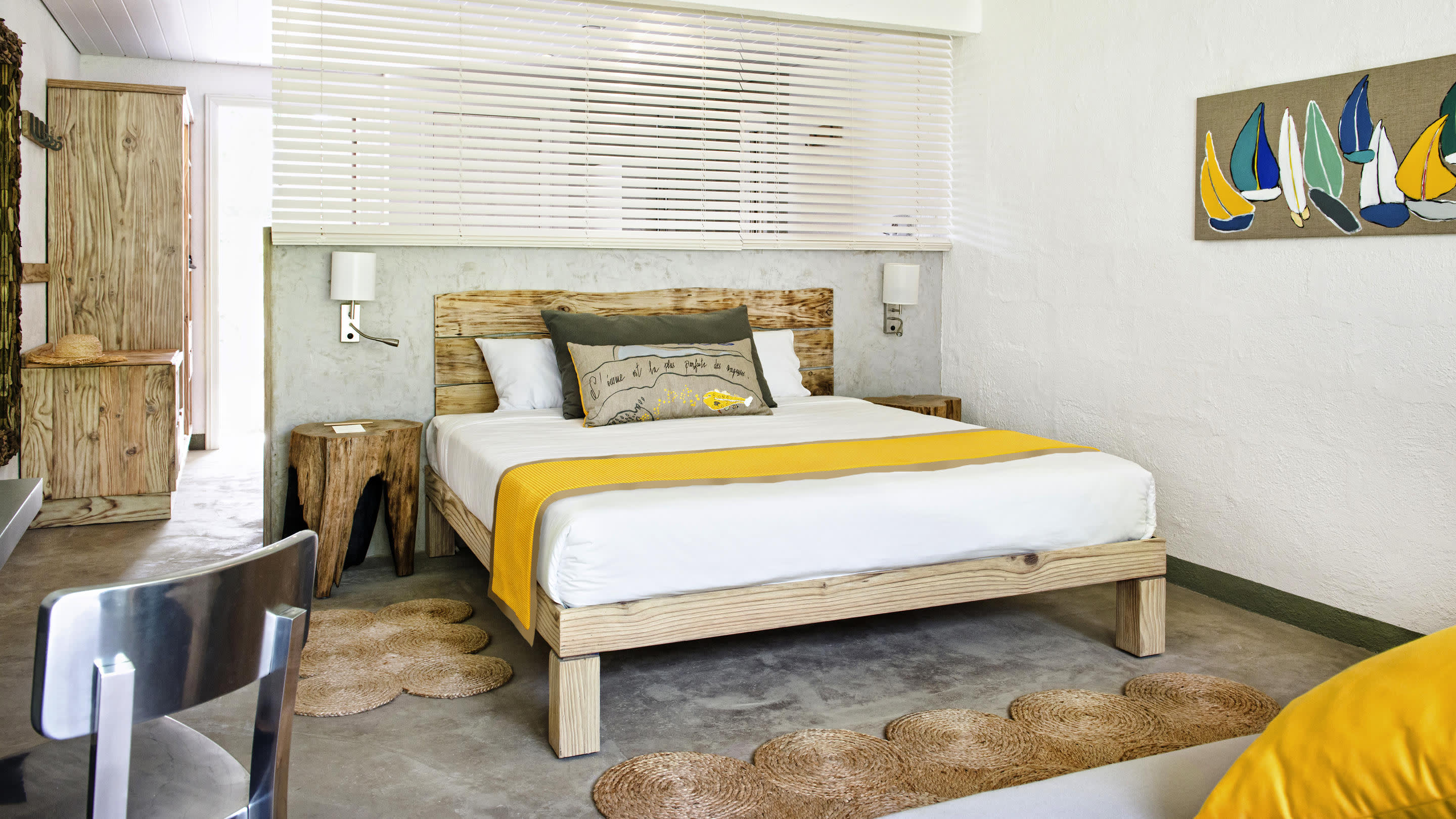 a bedroom with a bed and a chair in a room