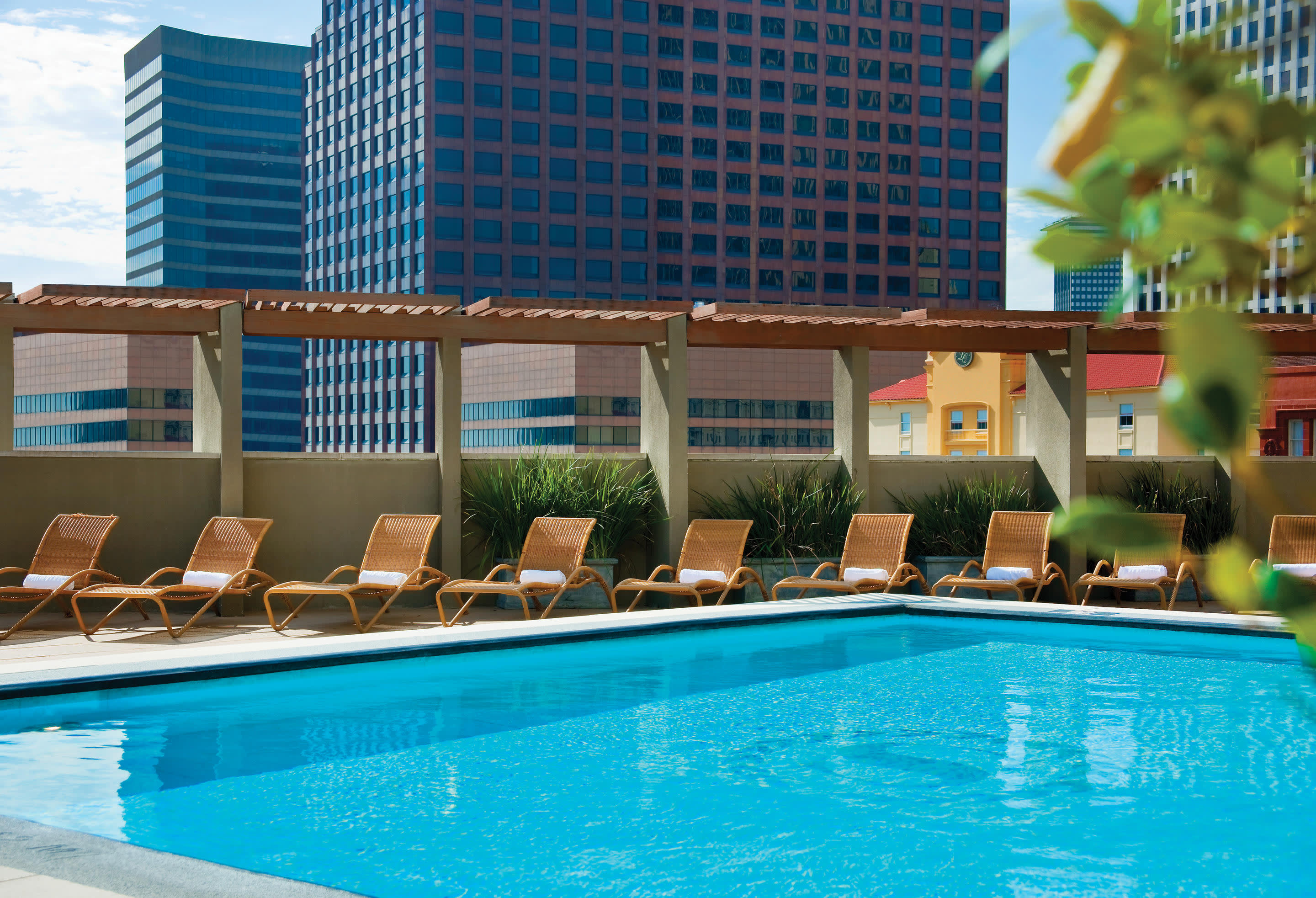 a blue pool of water in front of a building