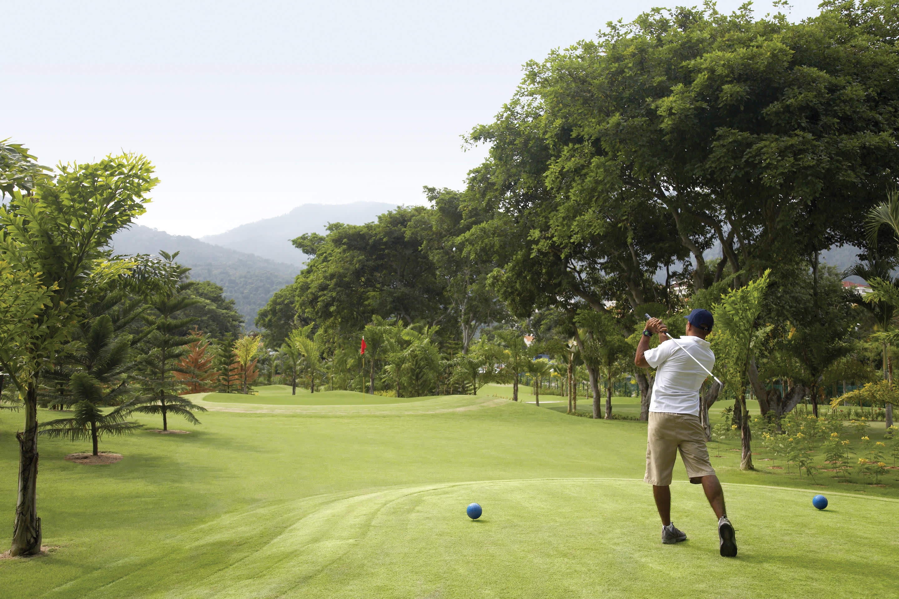 a man playing a game of frisbee in a park