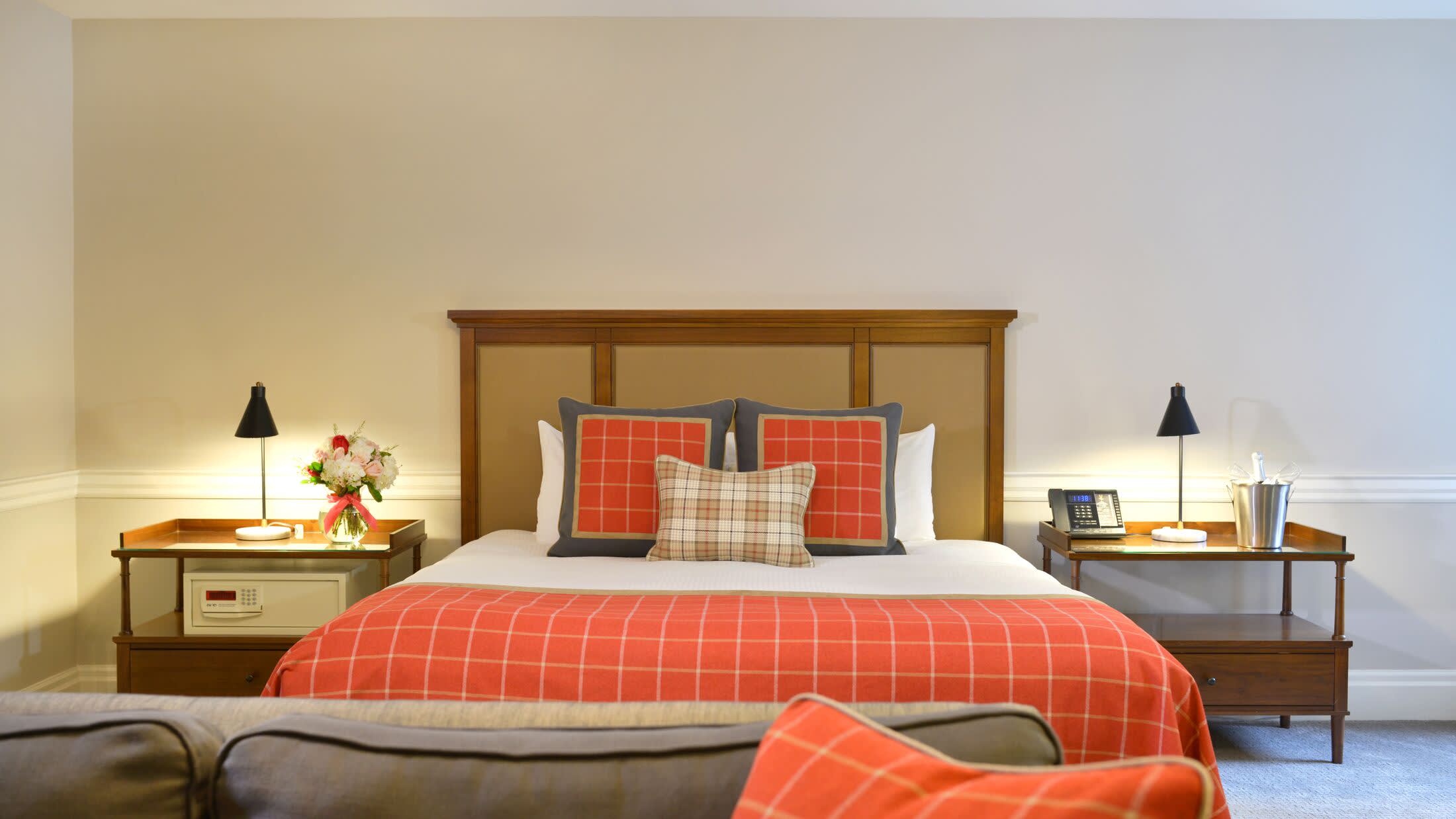 a bedroom with a large red chair in a room