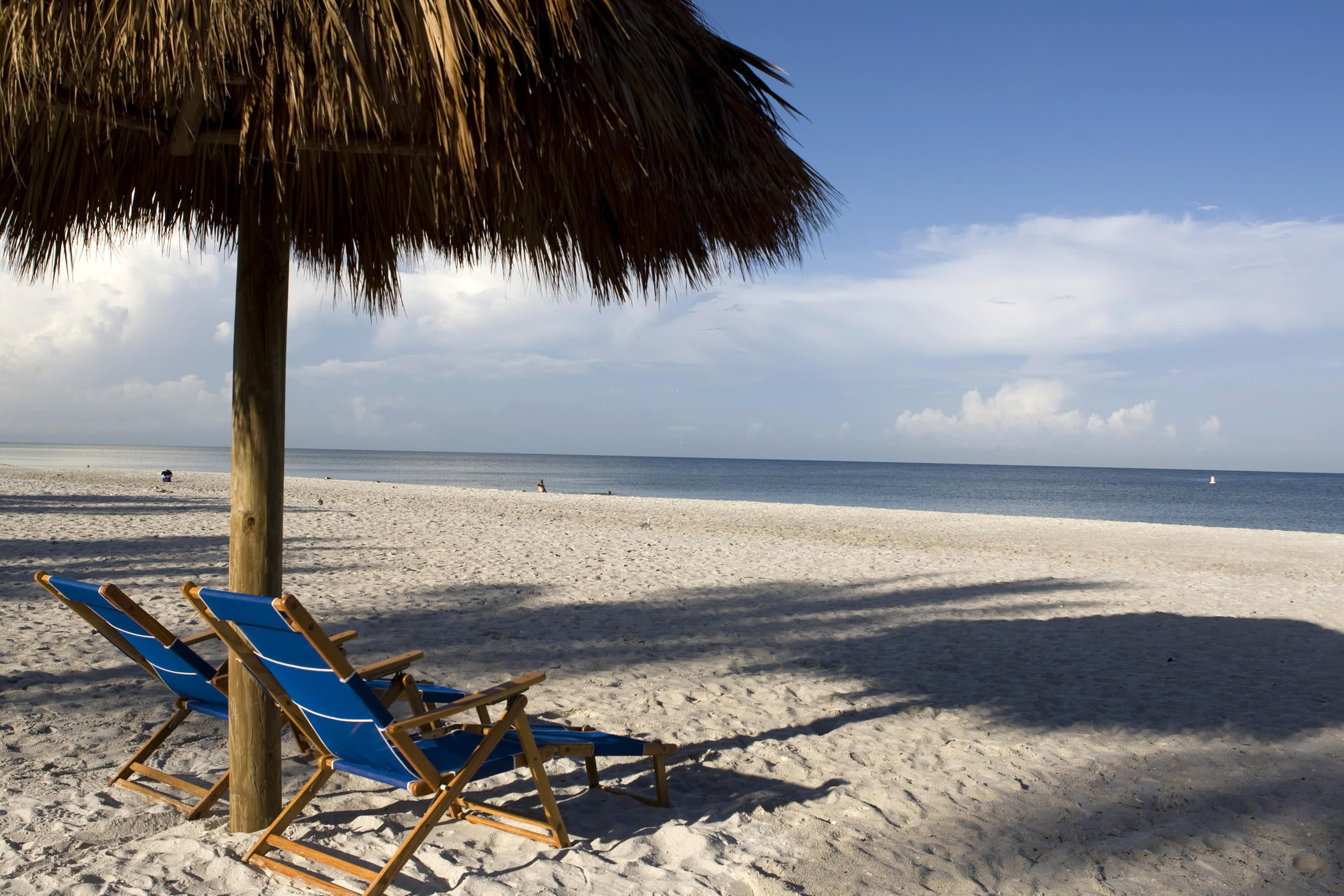 a person sitting on top of a sandy beach