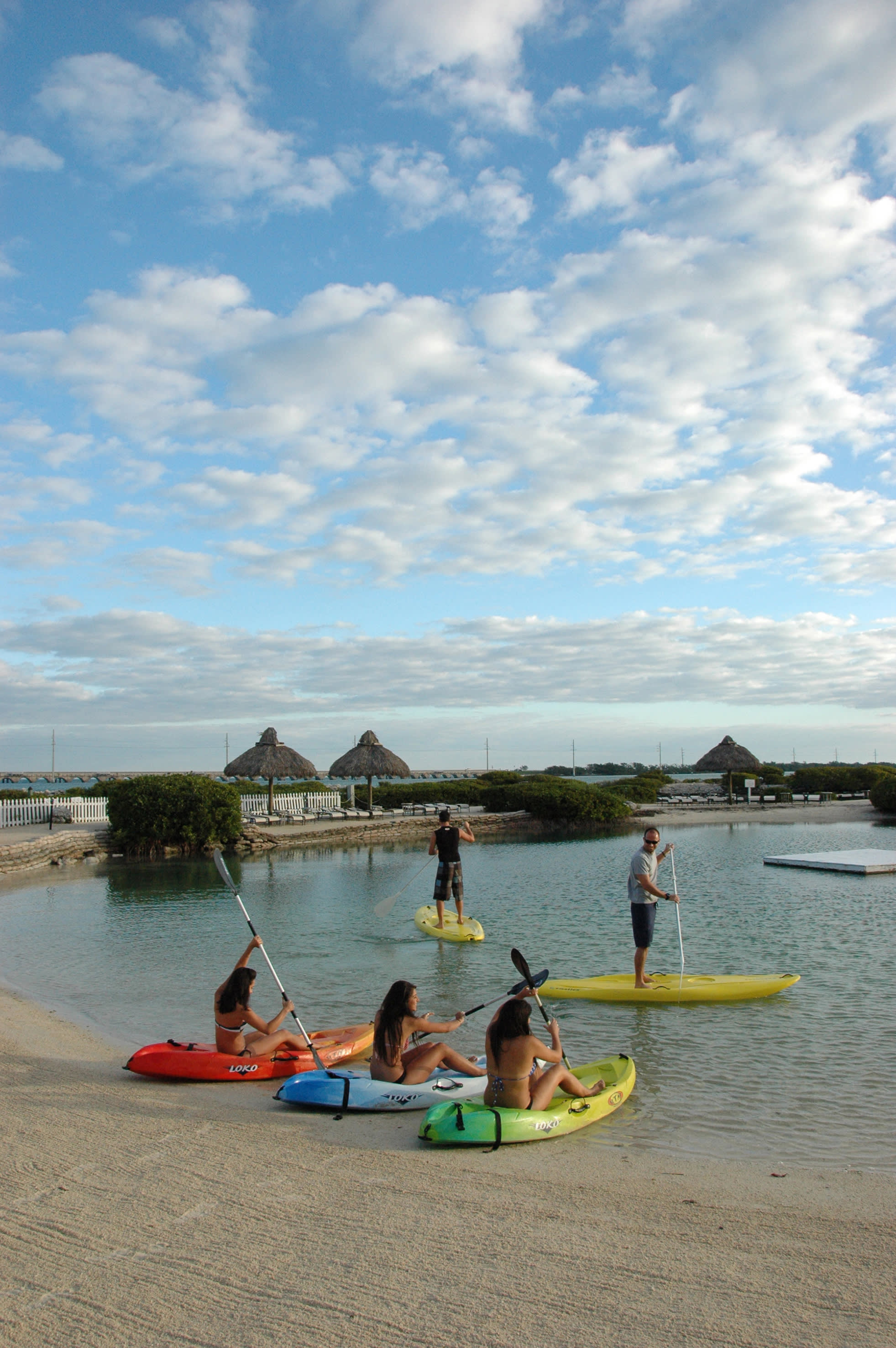 a group of people sitting in a boat on a body of water