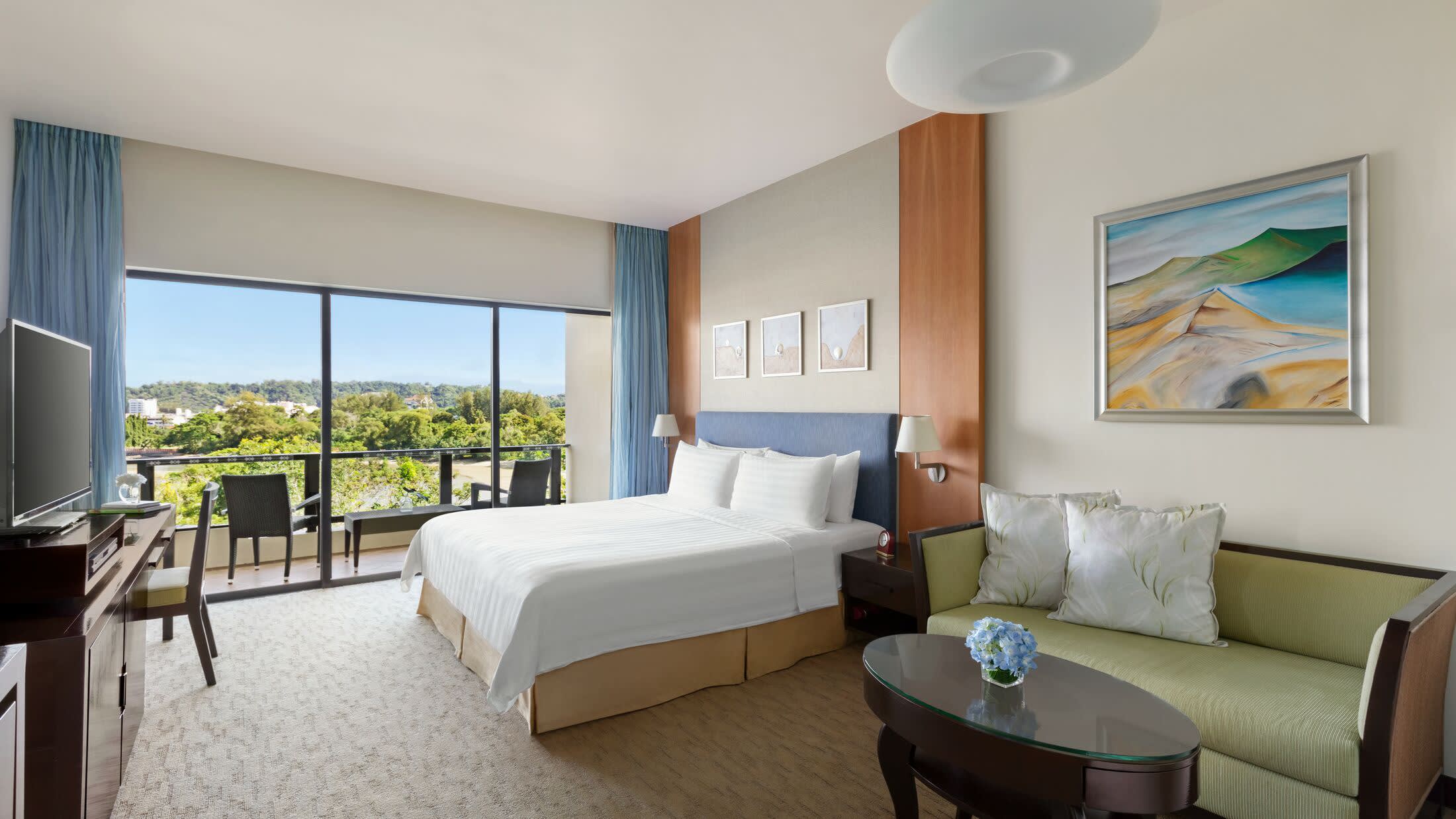a bedroom with a large bed in a hotel room