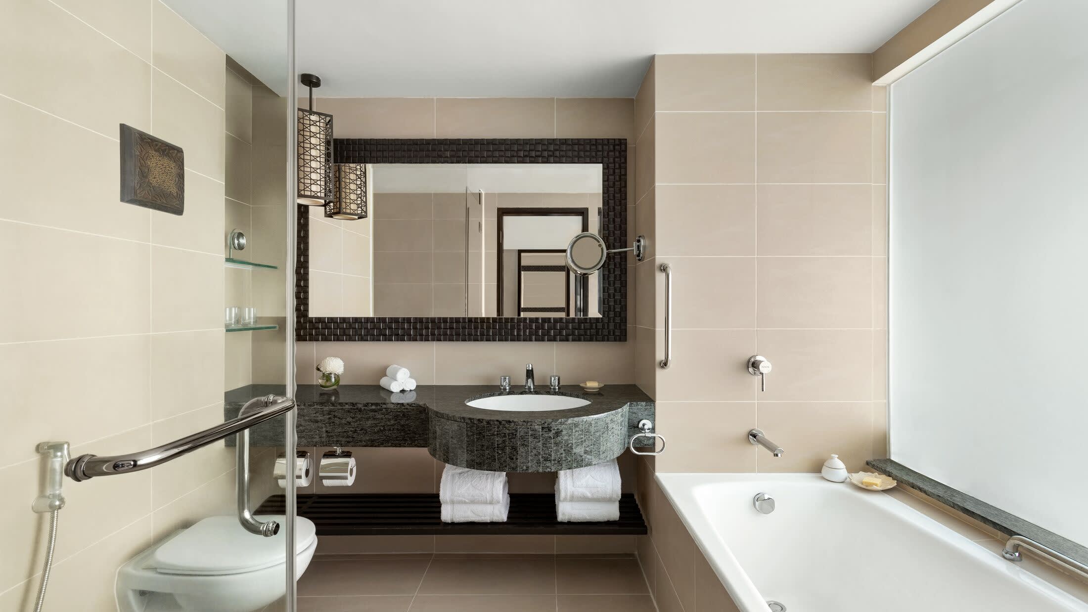 a white sink sitting under a mirror