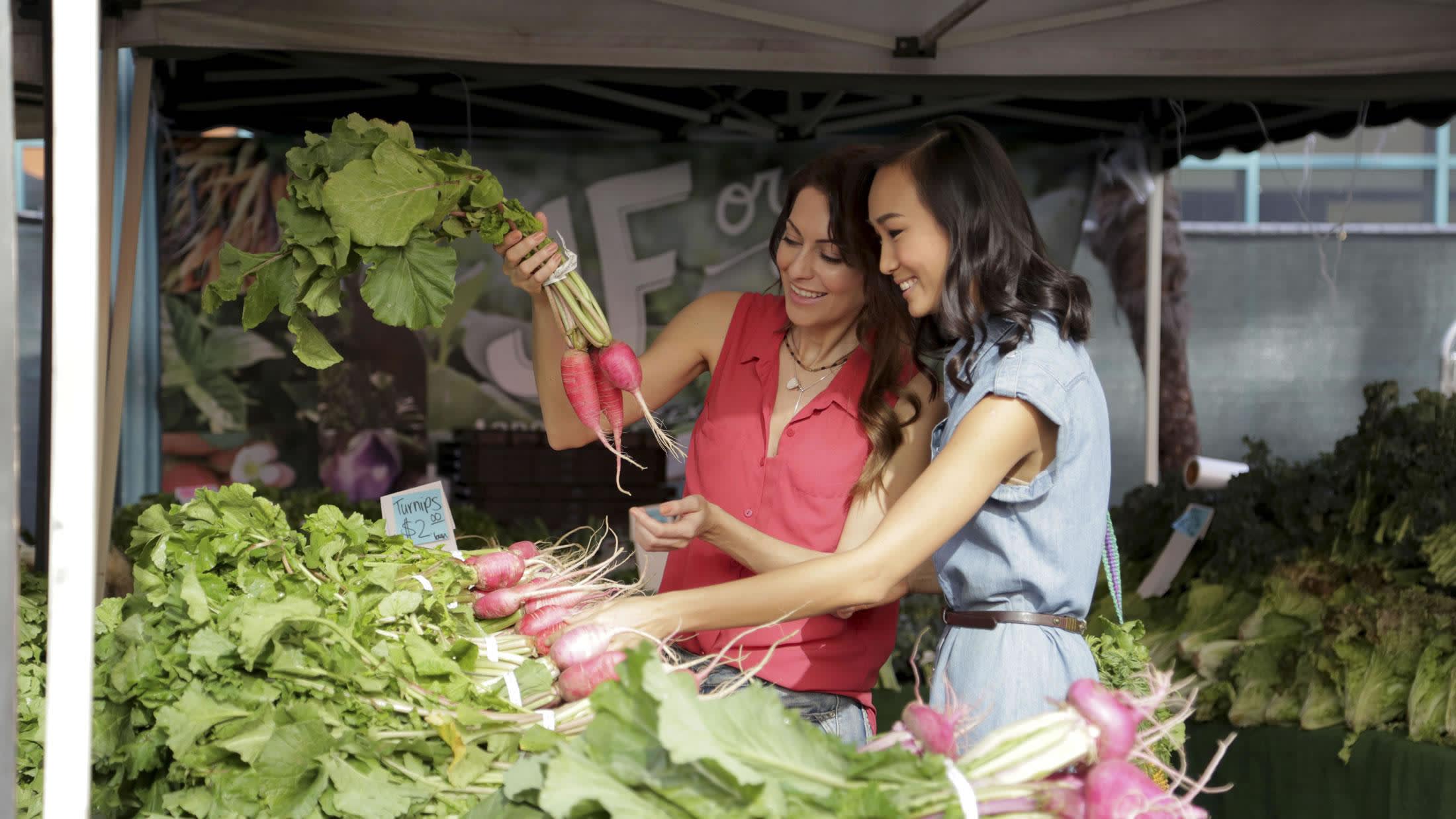 Nadia Lanfranconi standing in front of a produce stand