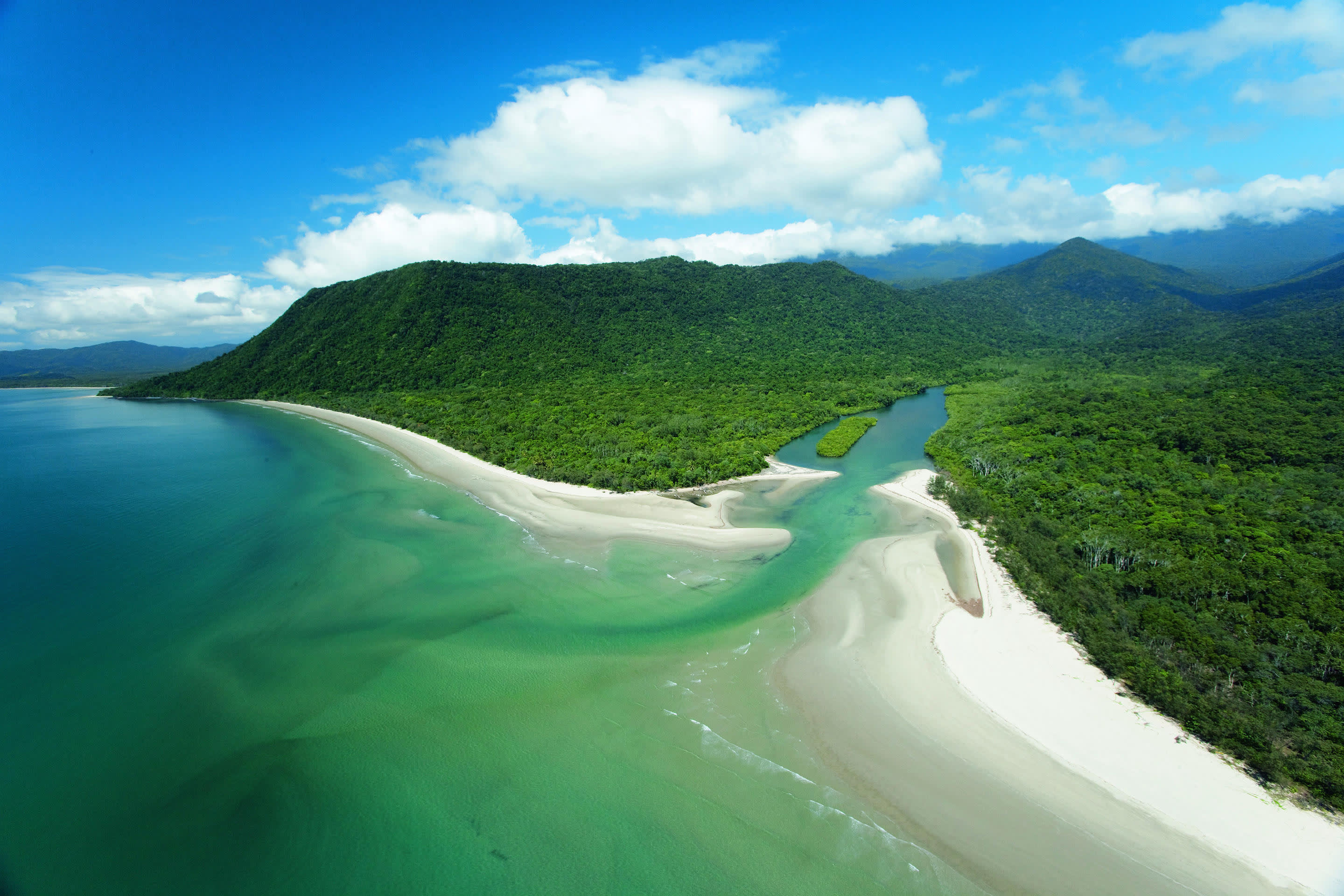 a body of water with Cape Tribulation, Queensland in the background