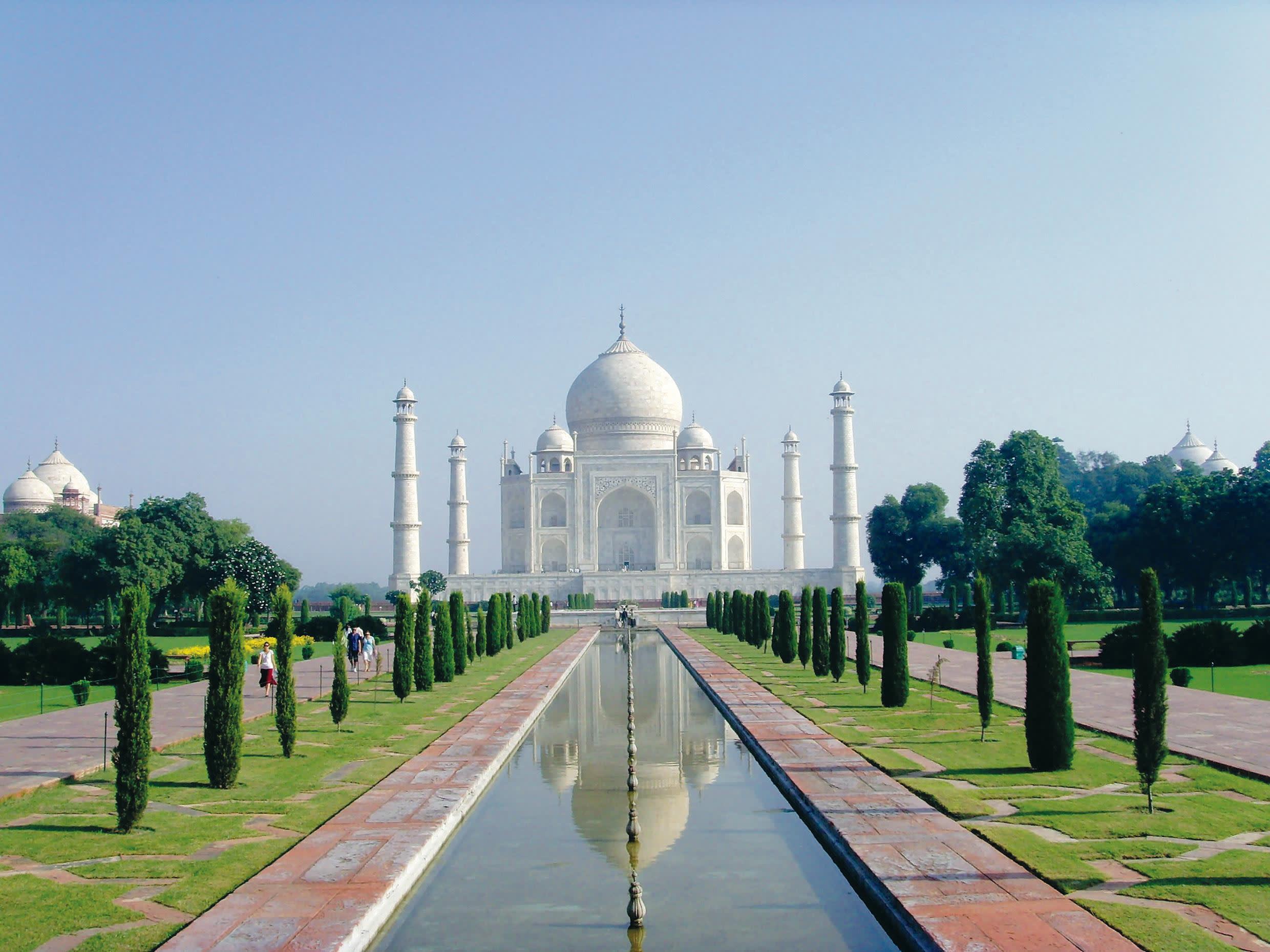 a large white building with Taj Mahal in the background