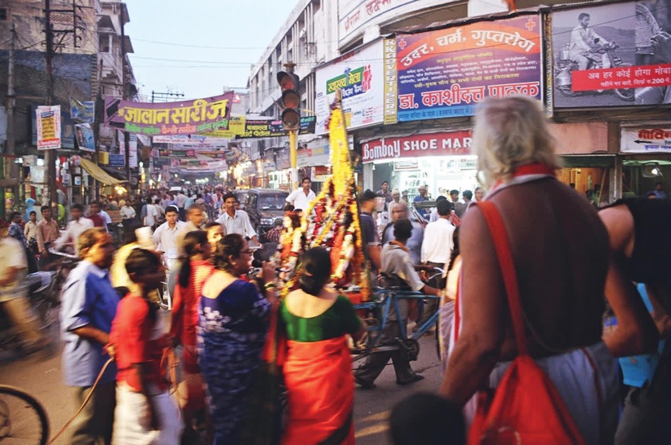 a group of people walking on a city street