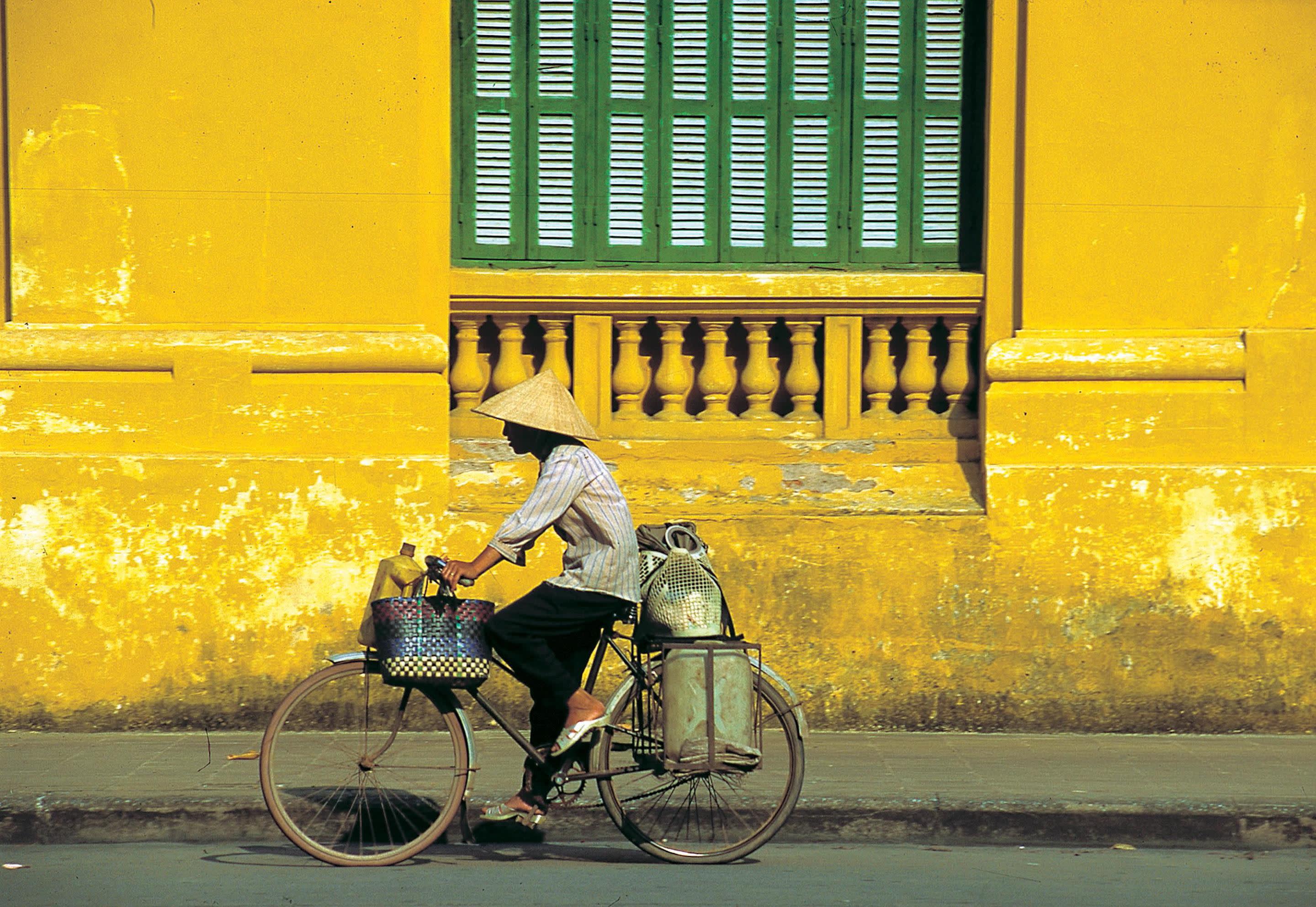 a person riding a bicycle in front of a building