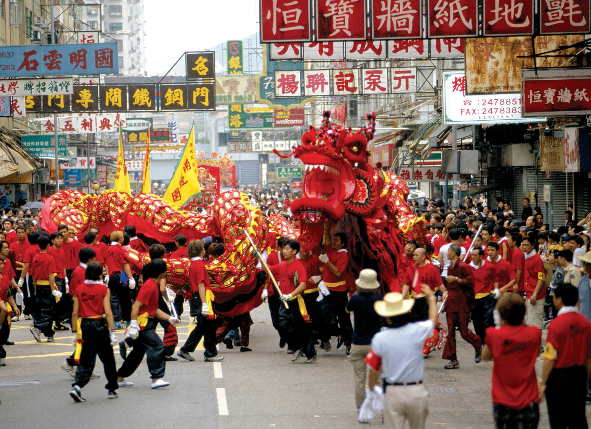 a group of people walking down the street in front of a crowd