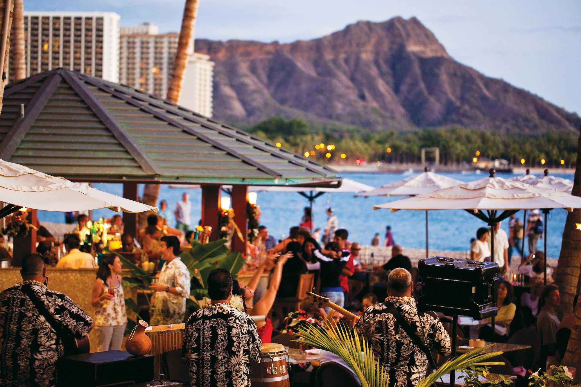 a group of people sitting at a table in front of a crowd