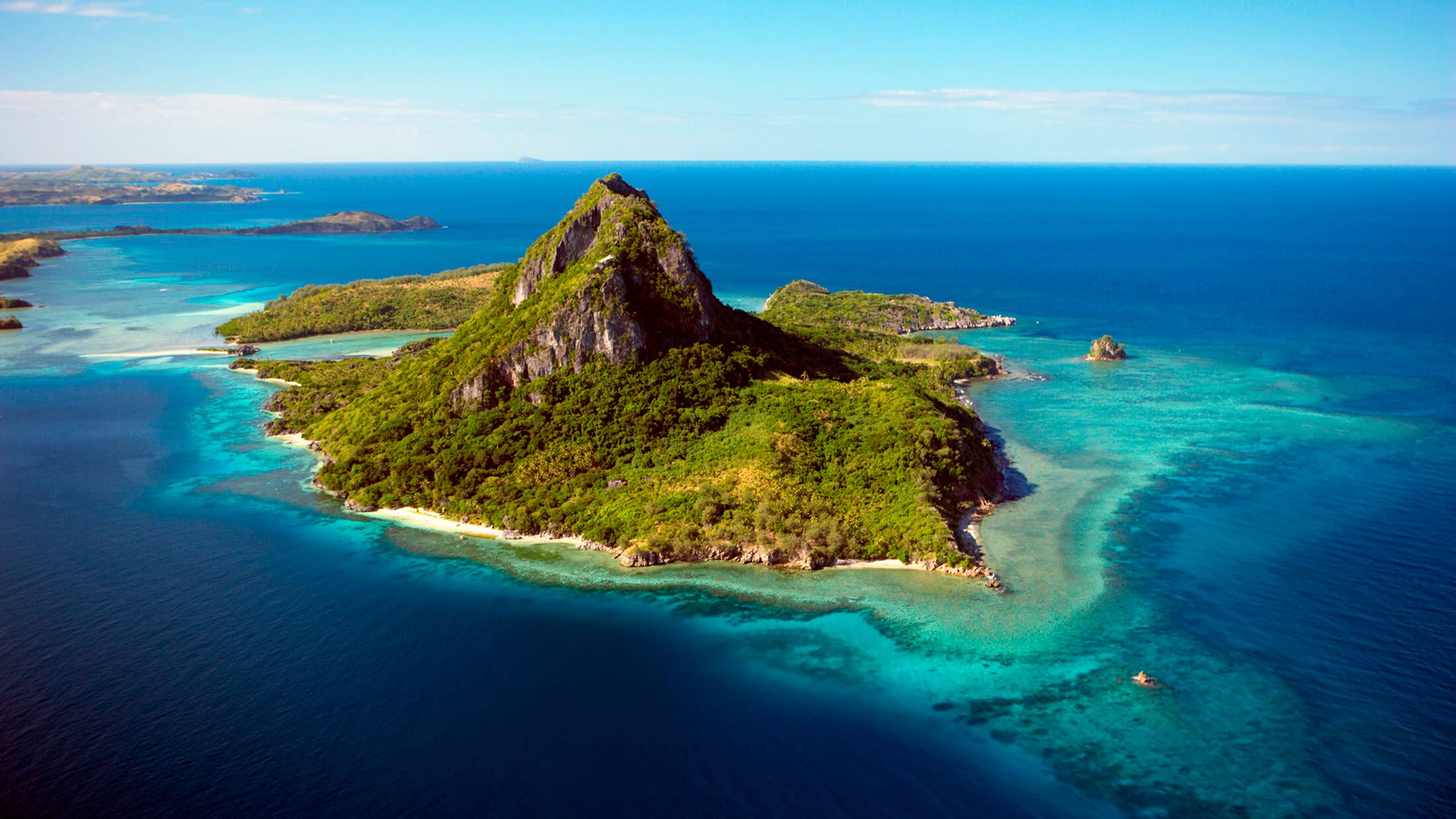 a rocky beach next to a body of water