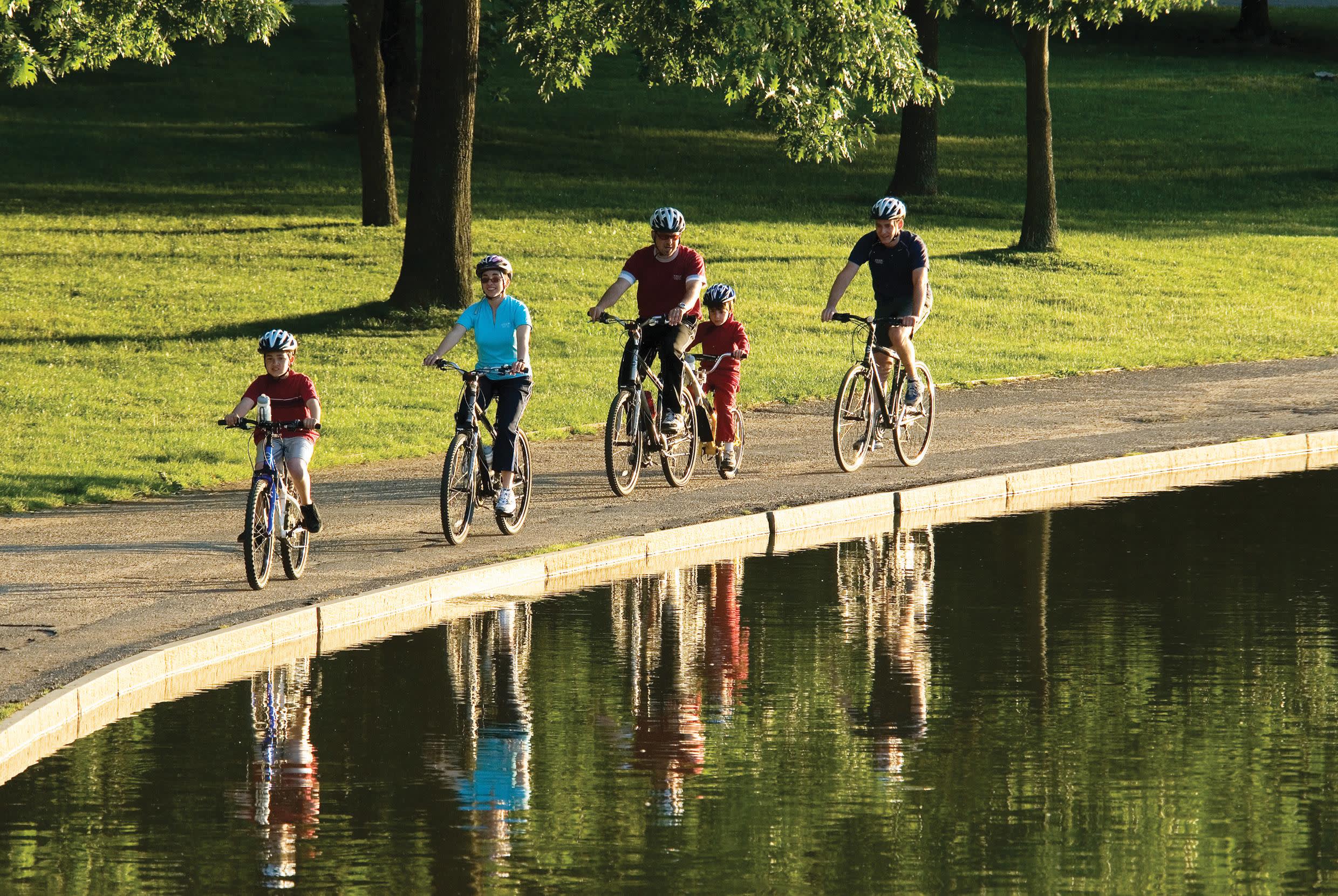 a group of people riding bikes down a river