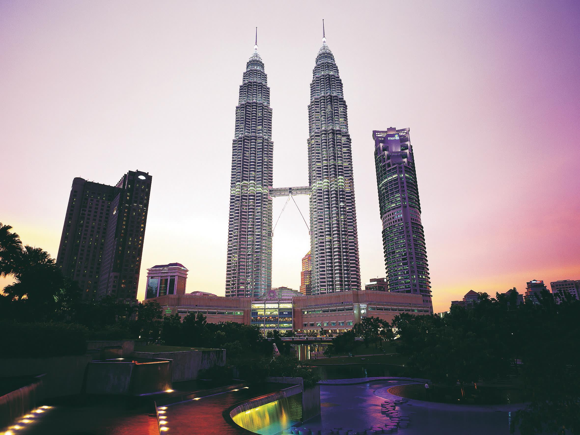 a view of Petronas Towers with tall buildings in the background