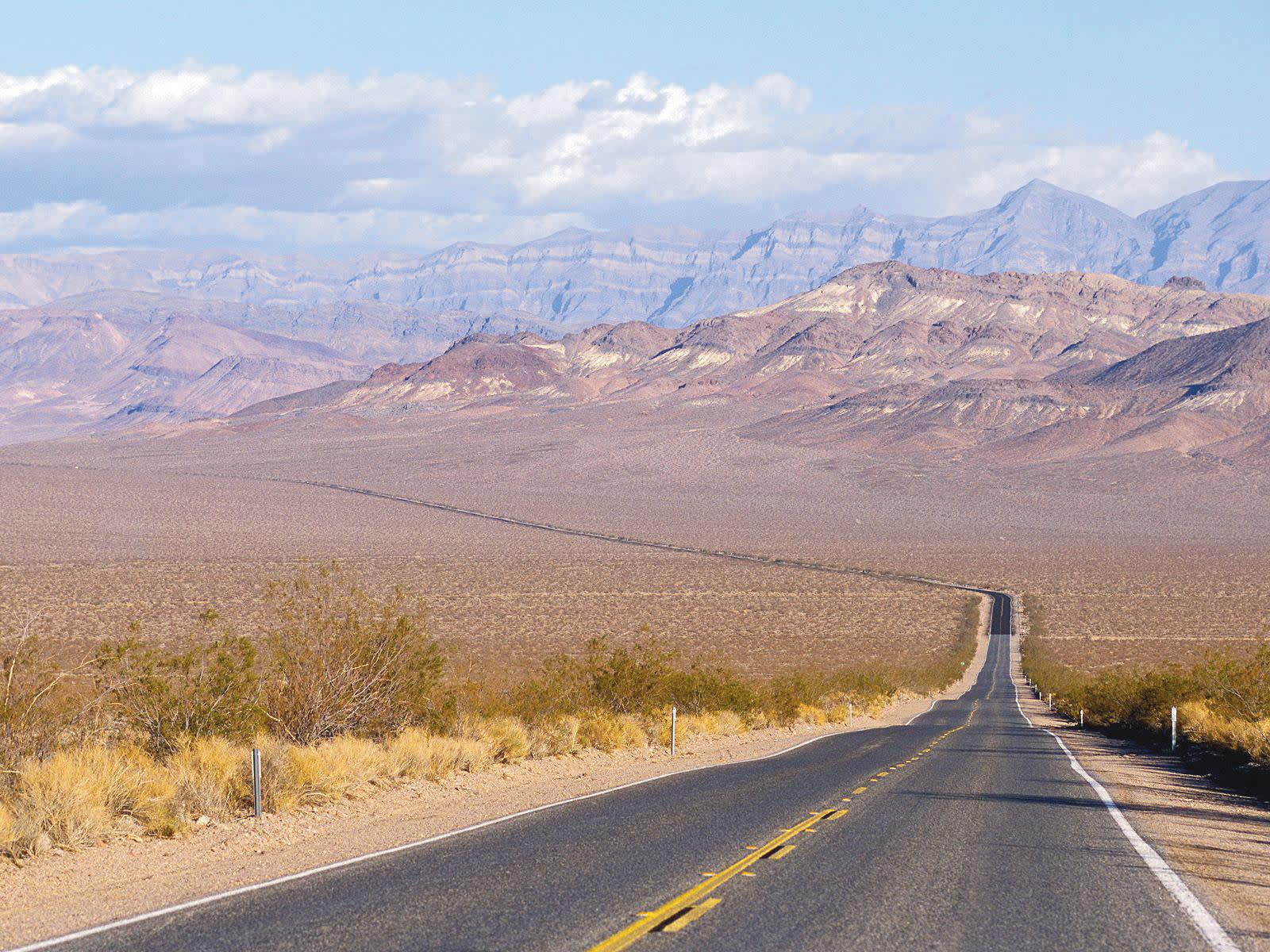 a road with a mountain in the background
