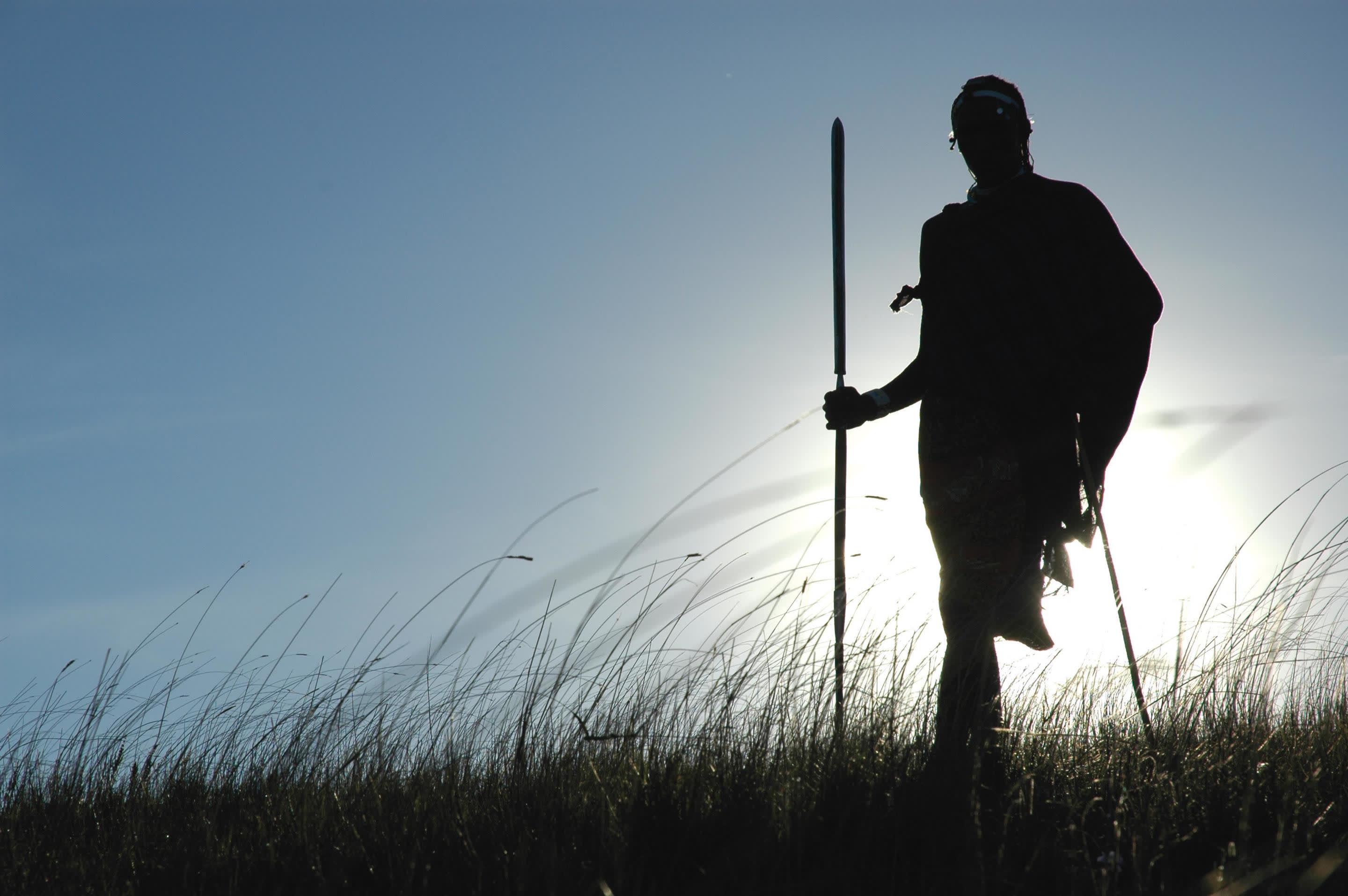 a man standing on top of a snow covered slope