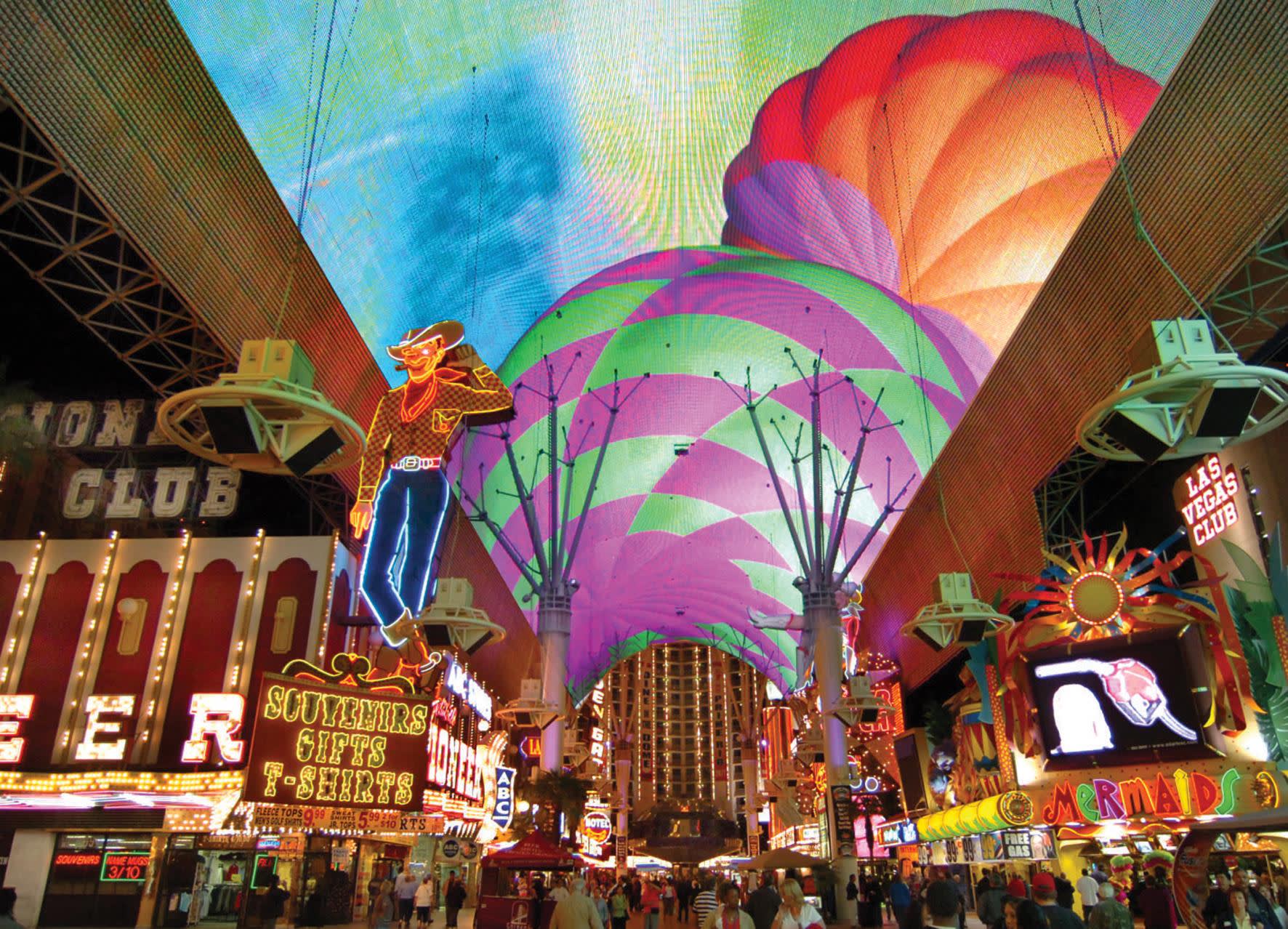 a group of colorful buildings with Fremont Street Experience in the background