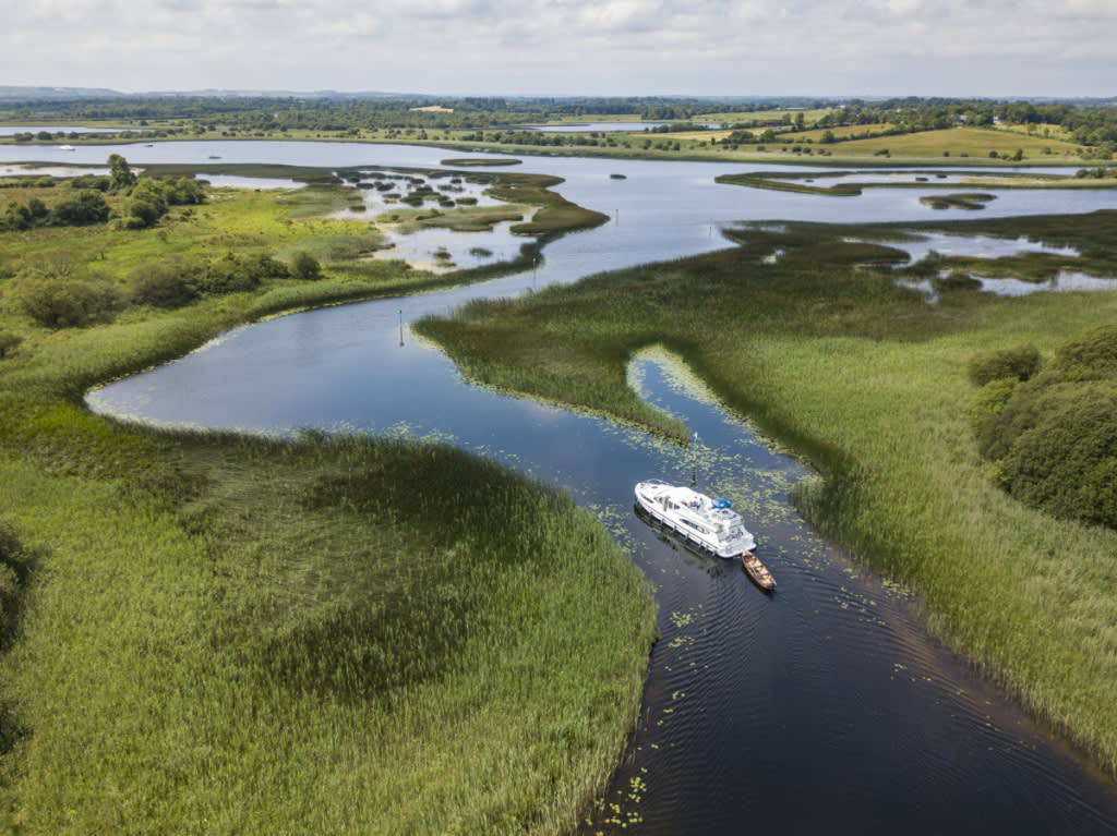 Le Boat cruiser navigating reed-lined waterways on the River Shannon in Ireland
