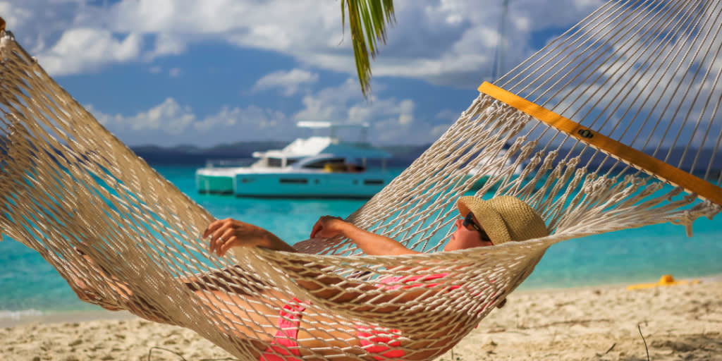 Woman in hammock relaxing on beach