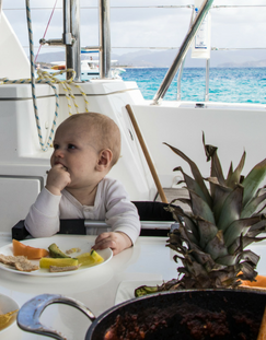 Baby eating on yacht