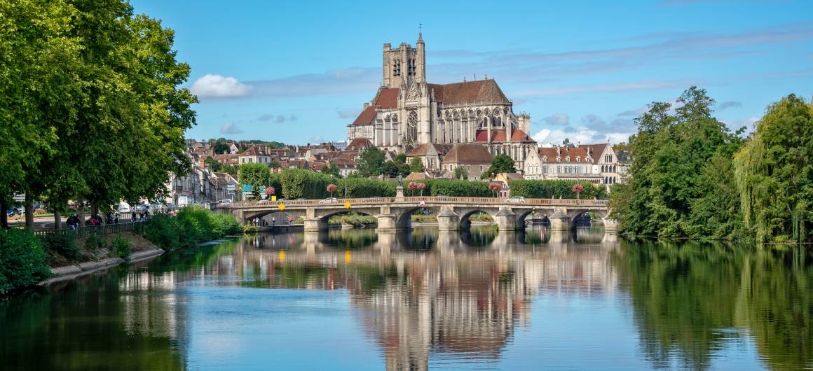 The impressive Saint-Étienne Cathedral dominates the skyline of Auxerre, viewed from across the river.