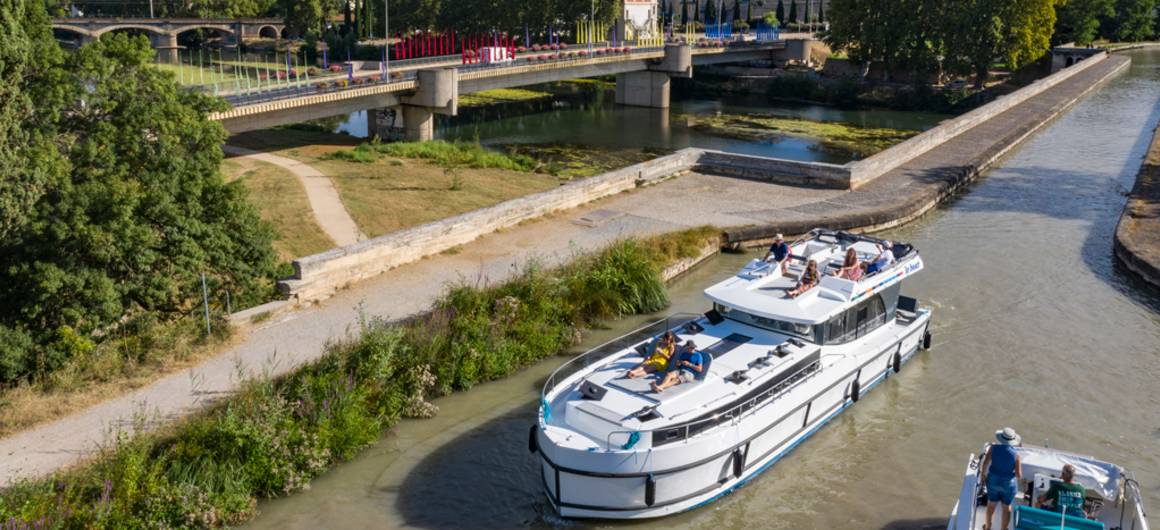 A view of Béziers Cathedral rising above the Canal du Midi aqueduct, combining cultural heritage with scenic cruising.