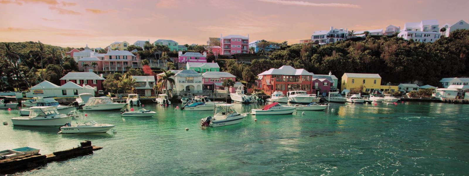 a small boat in a harbor next to a body of water