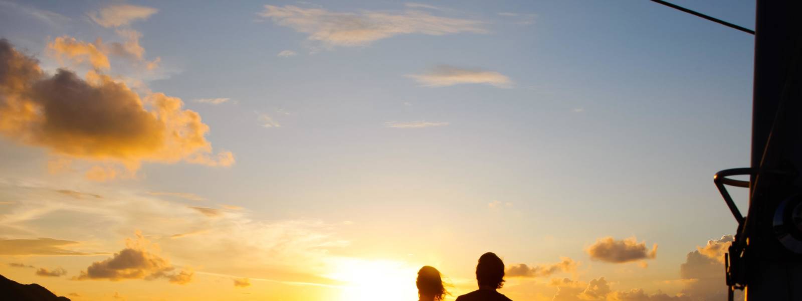 a person standing on a beach with a sunset in the background