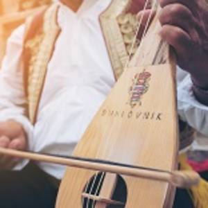 Man Plays Croatian Musical Instrument in Dubrovnik