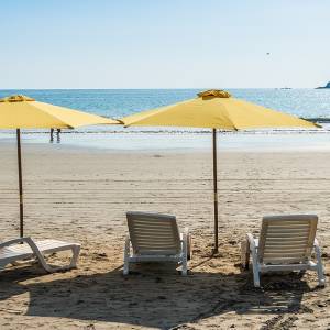 Enchanting Travels Costa Rica Tours Parasol with chairs at Playa Espadilla at Manuel Antonio Park