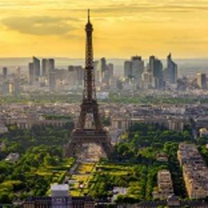 Enchanting Travels France Tours Skyline of Paris with Eiffel Tower at sunset in Paris, France. Eiffel Tower is one of the most iconic landmarks of Paris. Postcard of Paris