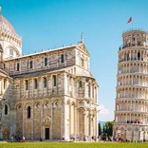 Enchanting Travels Italy Tours Leaning tower of Pisa, Italy with Basilica and Cathedral on a bright summer day with green gras low angle