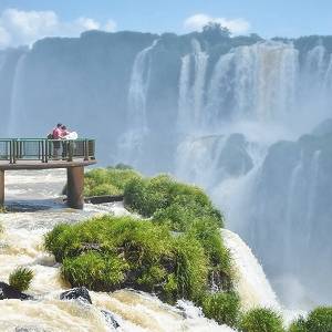 Iguazu falls national park on the border of Brazil and Argentina with tourists on wooden footbridges