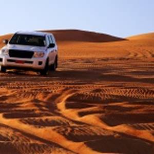 Off road vehicle on sand dunes, Oman