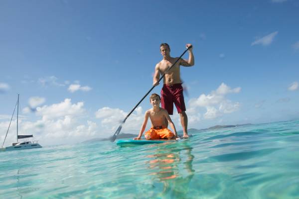 father and son paddleboarding in the bvi