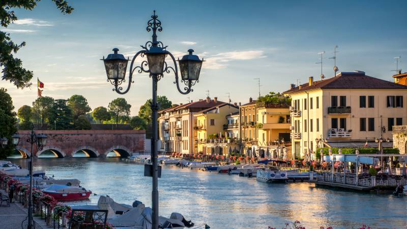 Boats and the bridge in port on Lake Garda, Peschiera del Garda, Italy