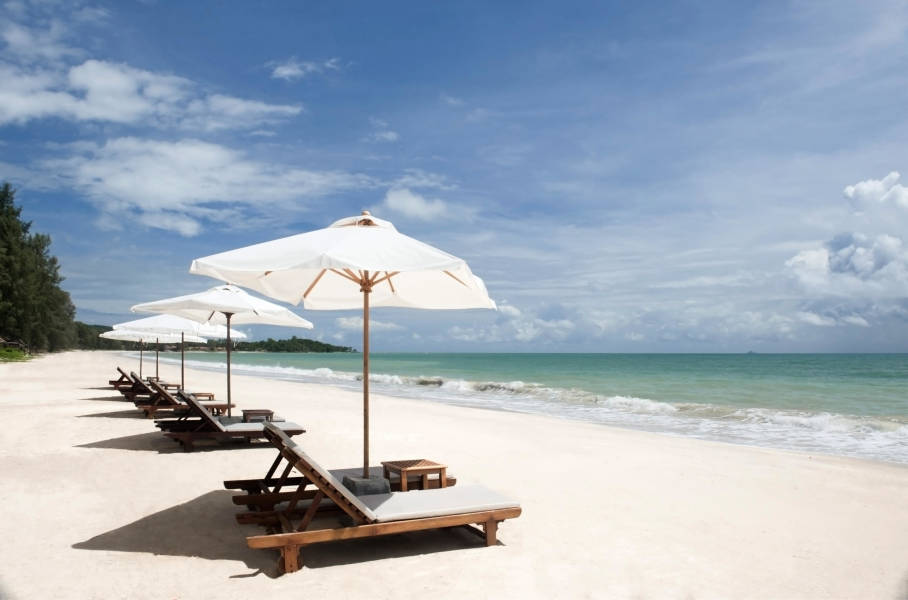an umbrella sitting on top of a sandy beach