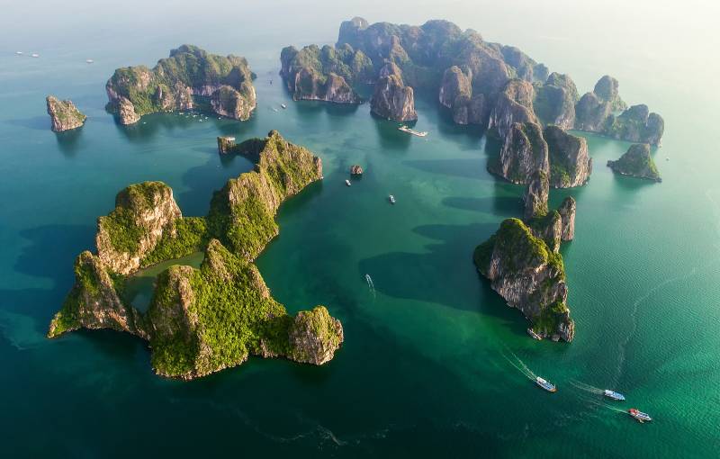 Aerial view of floating fishing village and rock island UNESCO World Heritage Site. Halong Bay, Vietnam