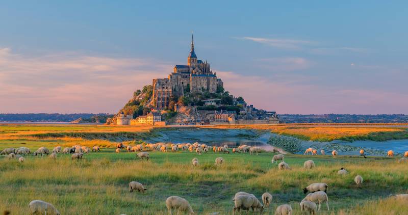 Enchanting Travels Europe Tours Mont Saint-Michel at sunset twilight in Normandy, northern France