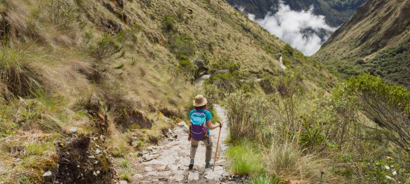 Advanture Woman along Inca Trail surround by Adean Moutain, Machu Picchu, Cusco, Peru