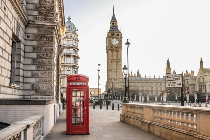 Enchanting Travels UK Ireland Tours London Big Ben tower and a red phone booth Telephone box empty streets