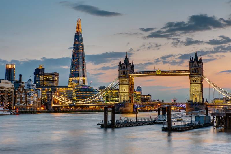 Enchanting Travels UK & Ireland Tours The Tower Bridge in London after sunset with the Shard in the back