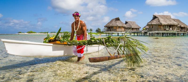 Local tahitian man was canoeing for food delivery