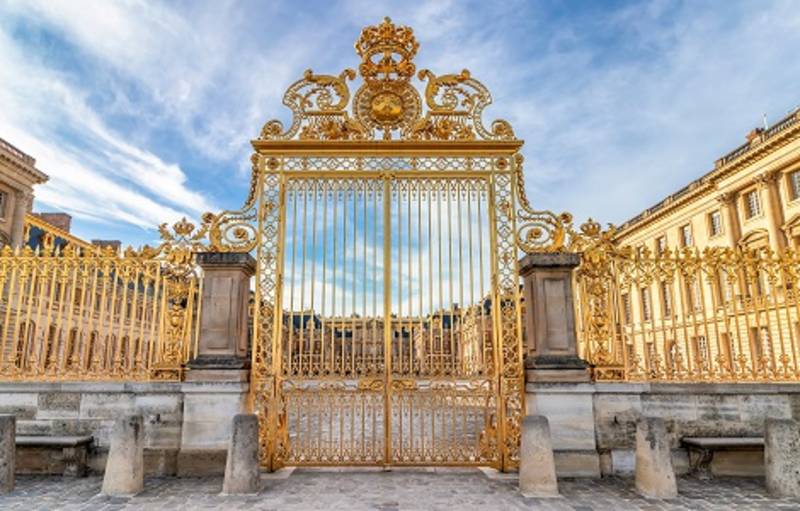 Main golden door in exterior facade of Versailles Palace, Paris, France